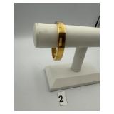SLG 14K GOLD OVER RESIN HINGED BANGLE BRACELET.