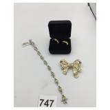 BRACELET GREEN STONES POSSIBLY.  BOW PIN BOXED