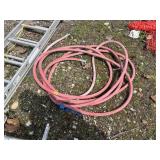 RED GARDEN HOSE W/ METAL CONNECTORS.