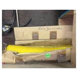 YELLOW STORM DRAIN CONES IN CARDBOARD BOXES.