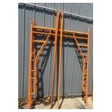 ORANGE METAL SCAFFOLDING FRAMES AND CROSS BRACES.