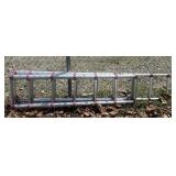 ALUMINUM TELESCOPING LADDER W/ RED ACCENTS.