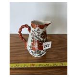 FLORAL DECORATED CERAMIC PITCHER, TWISTED HANDLE.