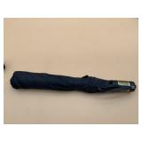BLACK FOLDING UMBRELLA, GOLD-TONE STRIPED HANDLE.