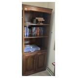 WOOD BOOKCASE W/ TWO SHELVES AND CABINET DOORS.
