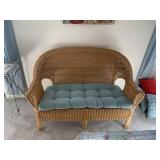 WICKER LOVESEAT W/ TUFTED SEAT CUSHION.