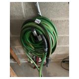 GREEN GARDEN HOSE, RUBBER, BRASS FITTINGS.