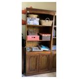 WOOD BOOKCASE W/ TWO SHELVES AND CABINET DOORS.