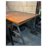 WORK TABLE W/ WOOD TOP, METAL SAWHORSE LEGS.