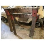 VTG WOODEN SAWHORSE W/ RED METAL BRACKETS.