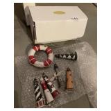 ASSORTED LIGHTHOUSE ORNAMENTS (6) AND LIFE RING