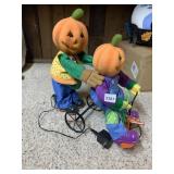 ANIMATED PUMPKIN FIGURES ON TRICYCLE, PLUSH