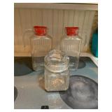 GLASS PITCHERS W/ RED LIDS, GLASS CANISTER W/