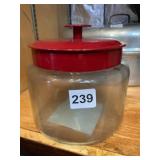KOEZE COMPANY GLASS STORAGE JAR, RED METAL LID,