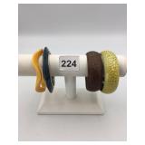 ASSORTED BANGLE BRACELETS, INCLUDES YELLOW WAVE