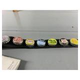 ASSORTED SODA BOTTLE CAPS, MOUNTED ON BLACK