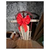 WOODEN SLED, METAL RUNNERS, DECORATIVE RED BOW.