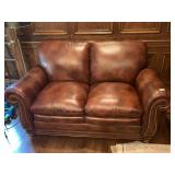 BROWN LEATHER LOVESEAT WITH BRASS NAILHEAD