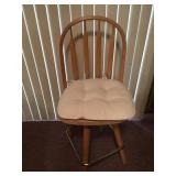 Three wood counter-height swivel bar stools