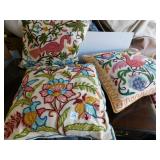 3 COLORFUL STITCHED PILLOWS. IN GOOD CONDITION.
