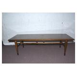 MID CENTURY COFFEE TABLE WITH DOVE TAILED ON TOP.