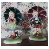PAIR OF CERAMIC UMBRELLA BOY & GIRL FIGURINES