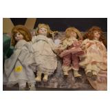 FOUR PORCELAIN DOLLS