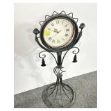 BATTERY OPERATED CLOCK ON METAL STAND -.