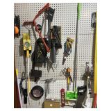CONTENTS OF PEG BOARD: BUCK SAW, PLIERS, ETC.