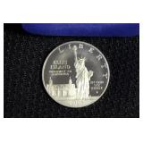 1986 ELLIS ISLAND SILVER DOLLAR IN CASE