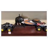 (2) TOY MONSTER TRUCKS, TOYABI REMOTE CONTROL BOAT