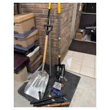 Two shovels a broom small drill press caulk gun