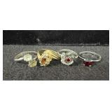 (4) COSTUME JEWELRY RINGS - VARYING SIZES