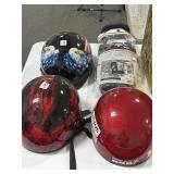 Three motorcycle helmets and waterproof rain boot