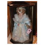 PORCELAIN DOLL IN DISPLAY CABINET