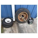 2 SMALL TRAILER WHEELS AND TIRES AND OLD BATTERIES