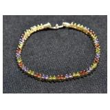 PERIDOT, AMETHYST AND GARNET TENNIS BRACELET