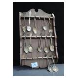 SOUVENIR SPOON RACK WITH 11 SILVERPLATE SPOONS &