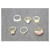 6 ASSORTED STERLING AND COSTUME RINGS - VARIOUS