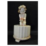 BABY HOLDING FLOWERS - 6 1/2" - TAN MARKED: U.S.