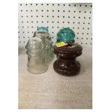 6 INSULATORS: 3 CLEAR GLASS, 2 GREEN GLASS AND A
