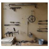 CONTENTS OF PEG BOARD: ANTIQUE SOLDERING IRONS,