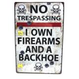 Tin sign: "No Trespassing I Own Firearms and a