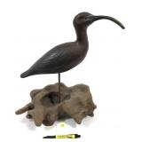 Wooden carved shorebird marked F, on driftwood
