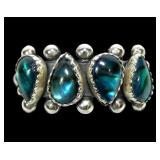 Sterling silver teardrop four-stone blue paua