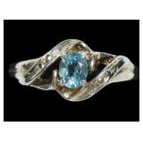 Sterling silver oval cut blue stone ring in bypass