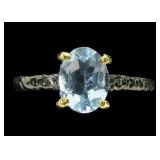 Rhodium plated sterling silver oval cut blue topaz