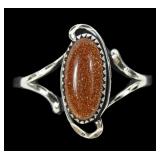Sterling silver dentil set goldstone ring with