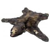 Black bear rug, tears in the arms