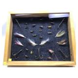 Display of assorted flies and large hooks in
